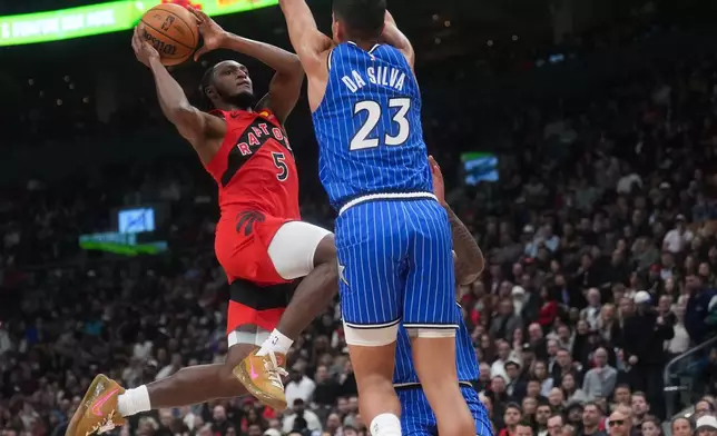 Toronto Raptors' Immanuel Quickley (5) shoots past Orlando Magic's Tristan da Silva (23) during the first half of an NBA basketball game in Toronto, Wednesday, Oct. 28, 2026. (Nathan Denette/The Canadian Press via AP)