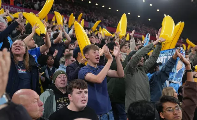 Manchester City fans cheer their team during the English Premier League soccer match between Liverpool and Manchester City in Liverpool, England, Sunday, Oct. 11, 2026. (AP Photo/Jon Super)