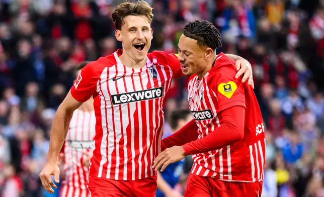 Freiburg's Maximilian Eggestein, left, celebrates after scoring the opening goal during the German Bundesliga soccer match between SC Freiburg and FC Schalke 04 in Freiburg, Germany, Sunday, Oct 11, 2026. (Tom Weller/dpa via AP)