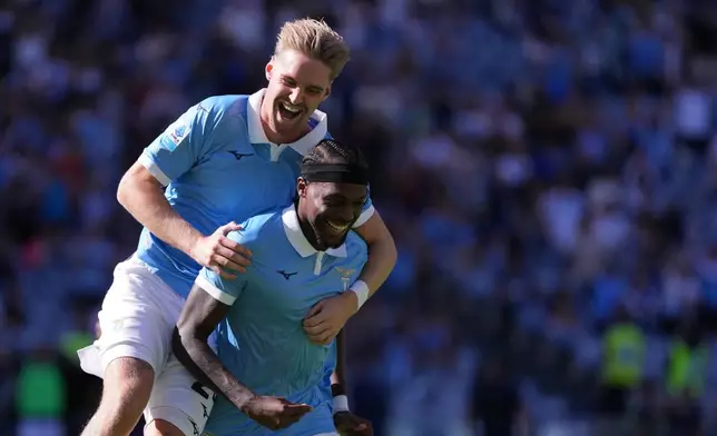 Lazio's Nuno Tavares, bottom, celebrates after scoring during the Serie A soccer match between Lazio and Monza in Rome, Sunday Oct. 11, 2026. ( Alfredo Falcone/LaPresse via AP)