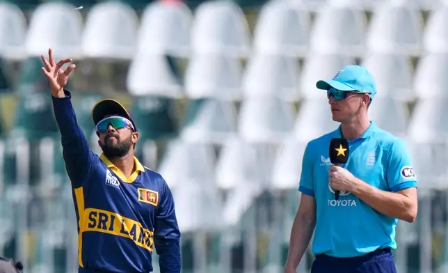Sri Lanka's captain Kusal Mendis tosses the coin as England captain Harry Brook watches before start of the tri-series one-day international cricket match between Sri Lanka and England, in Rawalpindi, Pakistan, Thursday, Oct. 22, 2026. (AP Photo/Anjum Naveed)