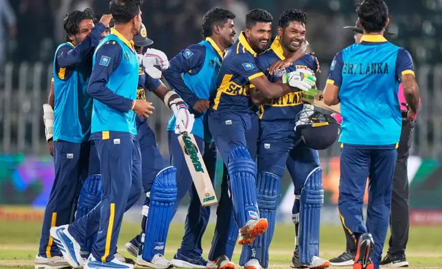 Sri Lanka's Janith Liyanage, second right, celebrates with teammates after hitting a winning run during the tri-series one-day international cricket match between Sri Lanka and England, in Rawalpindi, Pakistan, Thursday, Oct. 22, 2026. (AP Photo/Anjum Naveed)