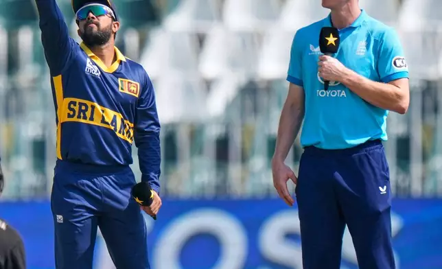 Sri Lanka's captain Kusal Mendis, left, flips the coin for toss as England's Harry Brook captain watches before start of the tri-series one-day international cricket match between Sri Lanka and England, in Rawalpindi, Pakistan, Thursday, Oct. 22, 2026. (AP Photo/Anjum Naveed)