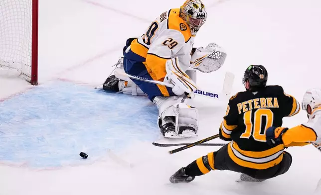 Boston Bruins' JJ Peterka (10) scores against Nashville Predators' Justus Annunen (29) during the second period of an NHL hockey game, Thursday, Oct. 22, 2026, in Boston. (AP Photo/Charles Krupa)