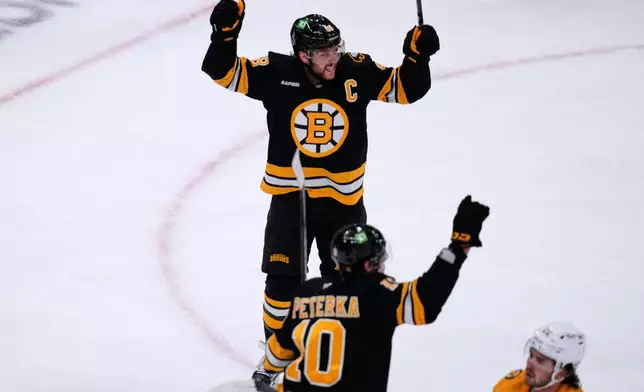 Boston Bruins' David Pastrnak, top, celebrates after his goal against the Nashville Predators during the second period of an NHL hockey game, Thursday, Oct. 22, 2026, in Boston. (AP Photo/Charles Krupa)