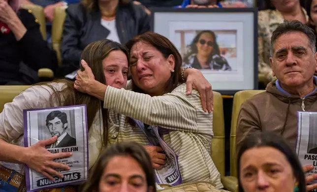 Relatives of Pascual Delfin Luduena, who disappeared during the last military dictatorship, embrace after a judge confirmed the identification of his remains found at the La Calera military base in Cordoba, Argentina, Friday, Oct. 23, 2026. (AP Photo/Rodrigo Abd)