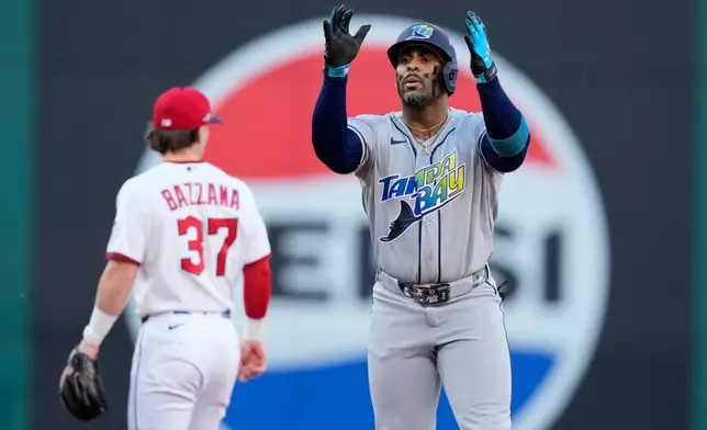 Tampa Bay Rays' Yandy Díaz celebrates a double against the Cleveland Guardians during the first inning in Game 5 of an American League Championship Series baseball game in Cleveland, Sunday, Oct. 18, 2026. (AP Photo/David J. Phillip)