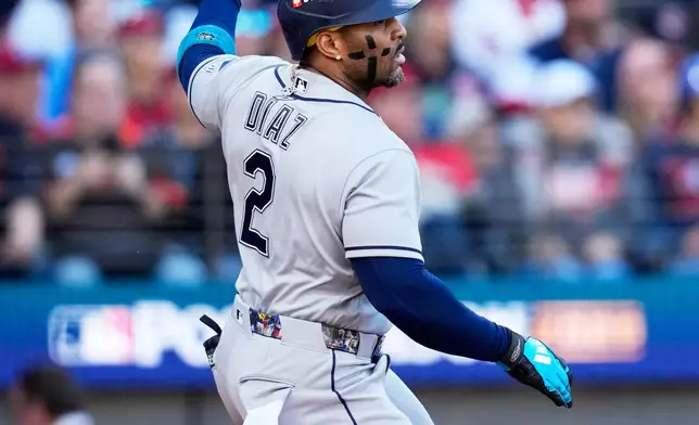 Tampa Bay Rays' Yandy Díaz hits a double against the Cleveland Guardians during the first inning in Game 5 of an American League Championship Series baseball game in Cleveland, Sunday, Oct. 18, 2026. (AP Photo/David J. Phillip)