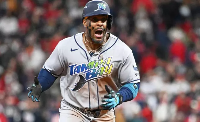 Tampa Bay Rays' Yandy Díaz celebrates a two-run home run against the Cleveland Guardians during the ninth inning in Game 4 of an American League Championship Series baseball game in Cleveland, Saturday, Oct. 17, 2026. (AP Photo/Phil Long)
