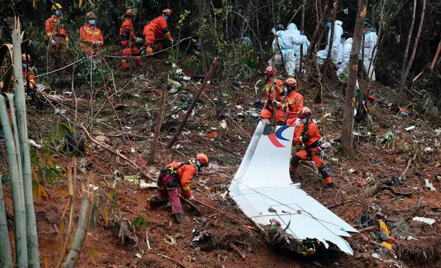 FILE - In this photo released by Xinhua News Agency, search and rescue workers search through debris at the China Eastern flight crash site in Tengxian County in southern China's Guangxi Zhuang Autonomous Region on March 24, 2022. (Lu Boan/Xinhua via AP, File)