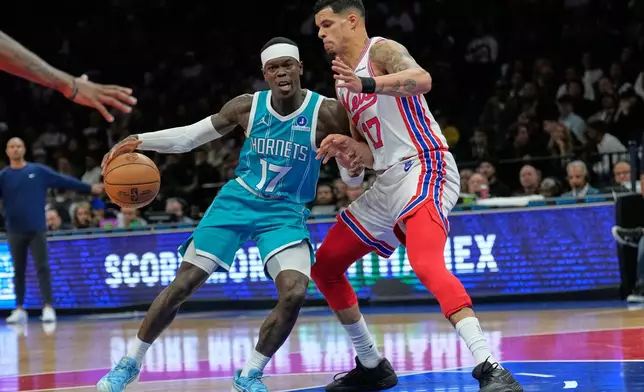 Brooklyn Nets' Michael Porter Jr., right, defends Charlotte Hornets' Dennis Schroder during the second half of an NBA basketball game Wednesday, Oct. 21, 2026, in New York. (AP Photo/Seth Wenig)
