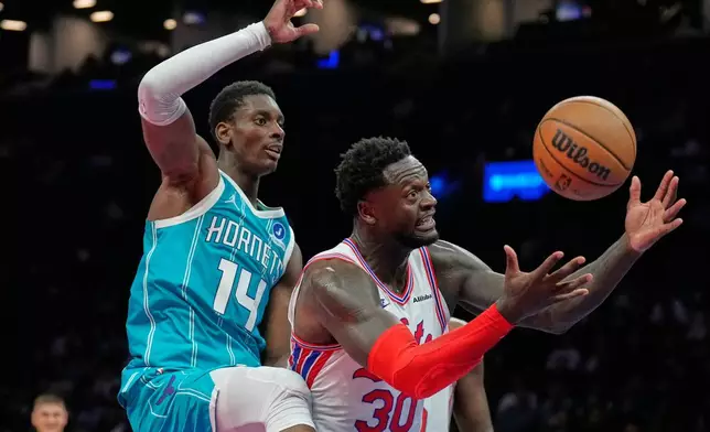 Charlotte Hornets' Moussa Diabate, left, and Brooklyn Nets' Julius Randle fight for a rebound during the second half of an NBA basketball game Wednesday, Oct. 21, 2026, in New York. (AP Photo/Seth Wenig)