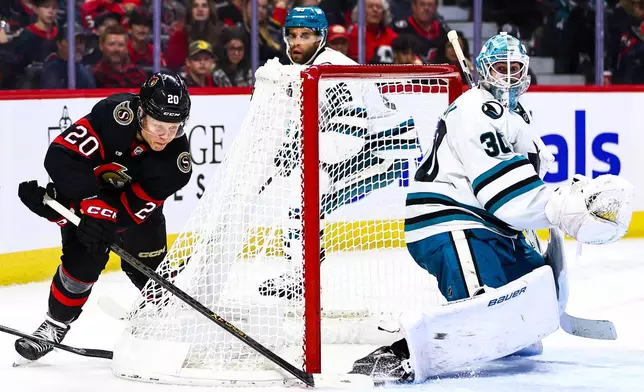 Ottawa Senators' Fabian Zetterlund (20) attempts a wraparound against San Jose Sharks goaltender Yaroslav Askarov (30) during the second period of an NHL hockey game in Ottawa, Ontario, Thursday, Oct. 22, 2026. (Keito Newman/The Canadian Press via AP)