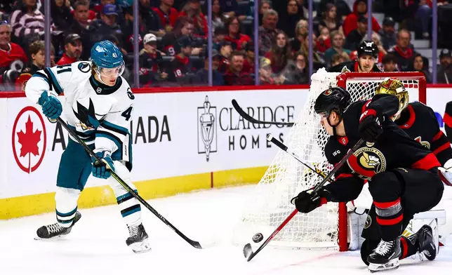 Ottawa Senators' Carter Yakemchuk, front right, attempts to block a shot by San Jose Sharks' Ivar Stenberg (41) during the first period of an NHL hockey game in Ottawa, Ontario, Thursday, Oct. 22, 2026. (Keito Newman/The Canadian Press via AP)