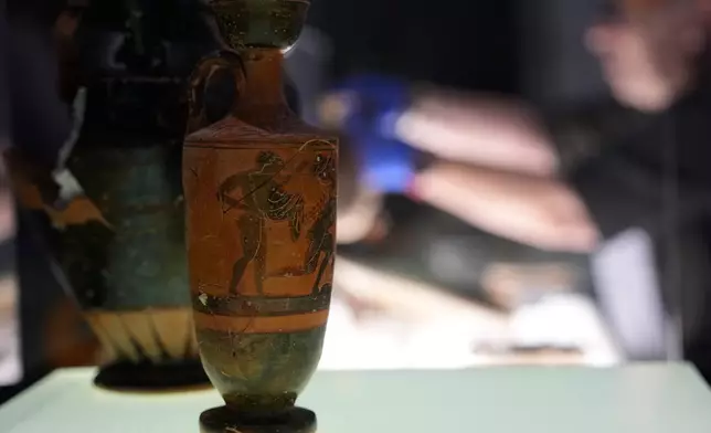 Greek antiquities dating to the 6th and 5th centuries B.C. are displayed during a repatriation ceremony at the National Archaeological Museum in Athens, Greece, Tuesday, Oct. 13, 2026, after 22 artifacts illegally removed from Greece were returned by Israel. (AP Photo/Thanassis Stavrakis)