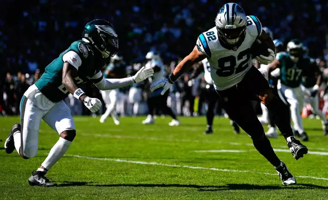 Carolina Panthers tight end Tommy Tremble (82) scores a touchdown as he gets by Philadelphia Eagles cornerback Quinyon Mitchell during the first half of an NFL football game in Philadelphia, Sunday, Oct. 18, 2026. (AP Photo/Matt Slocum)