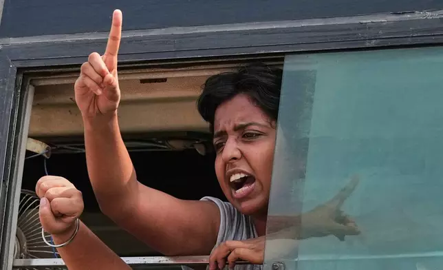 A protester shout slogans as they are detained and taken in a police vehicle during a protest demanding the resignation of Chief Election Commissioner Gyanesh Kumar in New Delhi, India, Saturday, Oct. 10, 2026. (AP Photo/Manish Swarup)