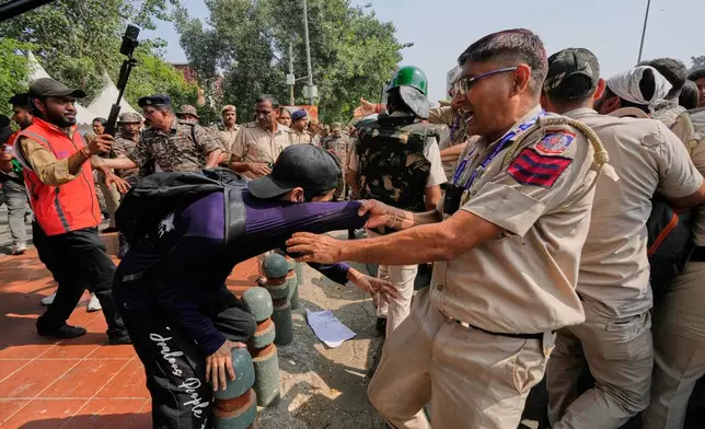 Police detain protesters during a demonstration demanding the resignation of Chief Election Commissioner Gyanesh Kumar in New Delhi, India, Saturday, Oct. 10, 2026.(AP Photo/Manish Swarup)