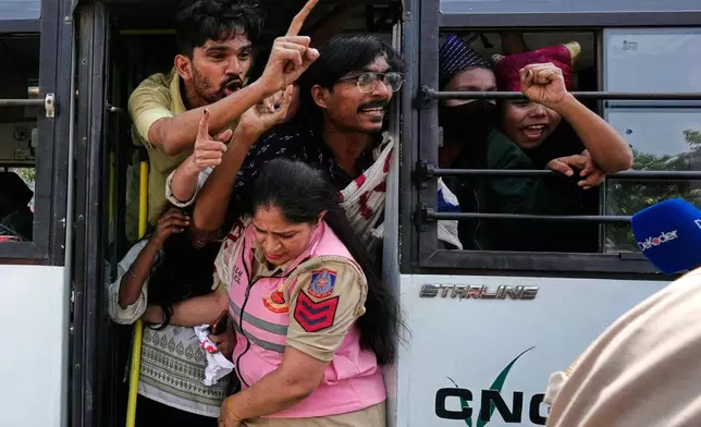 Protesters shout slogans from a police vehicle after being detained during a demonstration demanding the resignation of Chief Election Commissioner Gyanesh Kumar in New Delhi, India, Saturday, Oct. 10, 2026.(AP Photo/Manish Swarup)