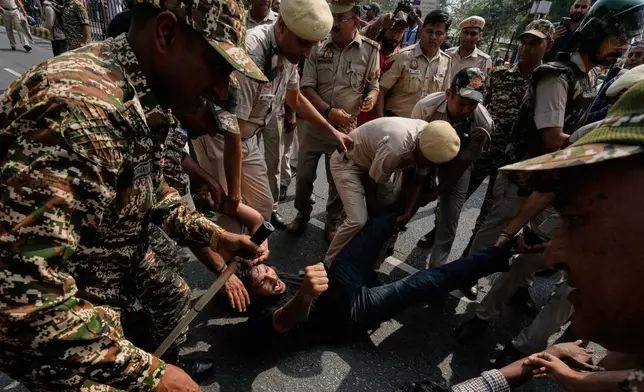 Police detain protesters during a demonstration demanding the resignation of Chief Election Commissioner Gyanesh Kumar in New Delhi, India, Saturday, Oct. 10, 2026.(AP Photo/Manish Swarup)