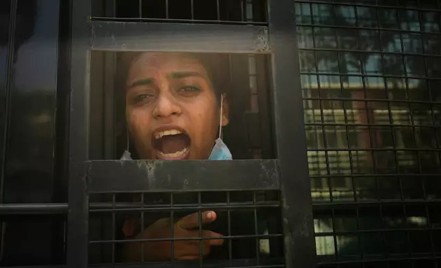 A protester shouts slogans from a police vehicle after being detained during a demonstration demanding the resignation of Chief Election Commissioner Gyanesh Kumar in New Delhi, India, Saturday, Oct. 10, 2026.(AP Photo/Manish Swarup)