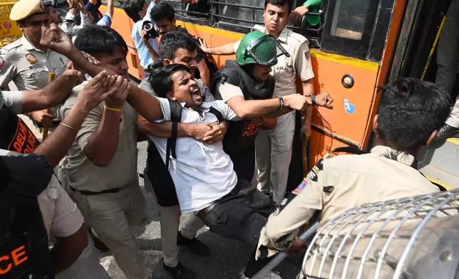 Policemen detain a protester during a youth demonstration demanding the resignation of the country's election chief Gyanesh Kumar, in New Delhi, India, Saturday, Oct. 10, 2026. (AP Photo/Vipin)