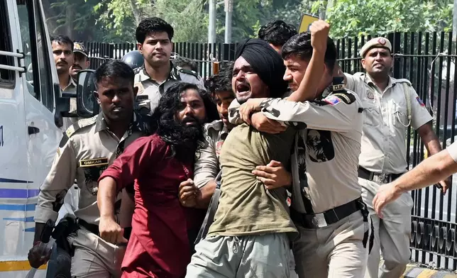 Policemen detain protesters during a youth demonstration demanding the resignation of the country's election chief Gyanesh Kumar, in New Delhi, India, Saturday, Oct. 10, 2026. (AP Photo/Vipin)