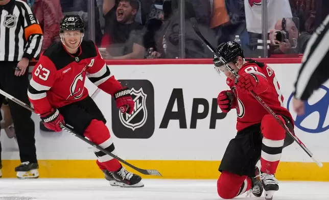 New Jersey Devils' Arseny Gritsyuk, right, celebrates his goal during the third period of an NHL hockey game against the Colorado Avalanche in Newark, N.J., Tuesday, Oct. 20, 2026. (AP Photo/Seth Wenig)