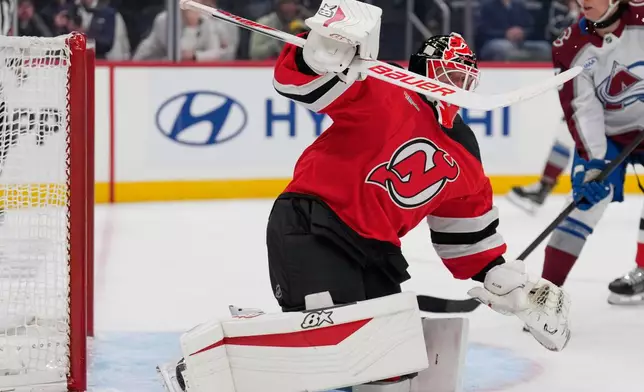 New Jersey Devils goaltender Jake Allen defends the goal during the first period of an NHL hockey game against the Colorado Avalanche in Newark, N.J., Tuesday, Oct. 20, 2026. (AP Photo/Seth Wenig)