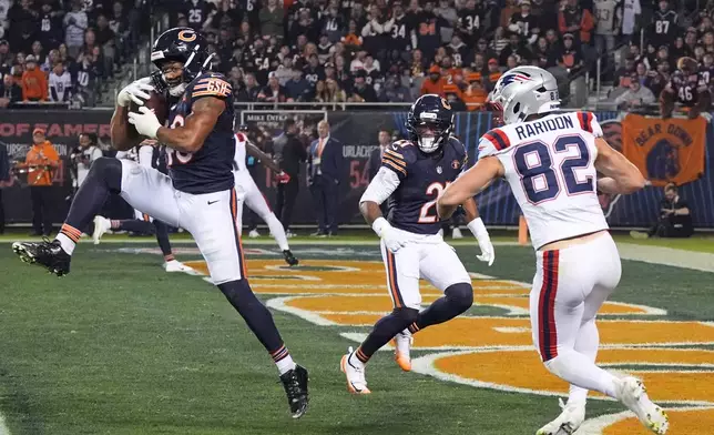 Chicago Bears linebacker D'Marco Jackson (48) intercepts a pass intended for New England Patriots tight end Eli Raridon (82) as Cam Lewis, center, looks on during the first half of an NFL football game in Chicago, Thursday, Oct. 22, 2026. (AP Photo/David Banks)