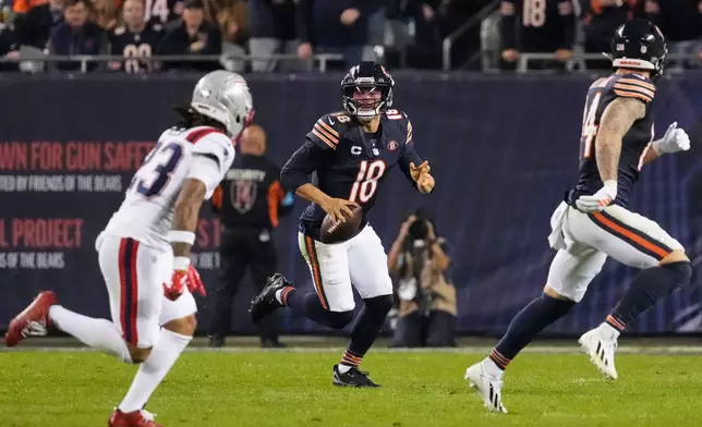 Chicago Bears quarterback Caleb Williams (18) scrambles as during the second half of an NFL football game against the New England Patriots in Chicago, Thursday, Oct. 22, 2026. (AP Photo/Nam Y. Huh)