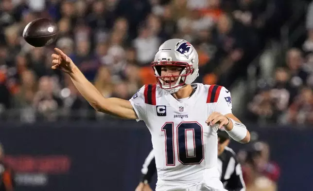 New England Patriots quarterback Drake Maye throws a pass during the first half of an NFL football game against the Chicago Bears in Chicago, Thursday, Oct. 22, 2026. (AP Photo/Nam Y. Huh)