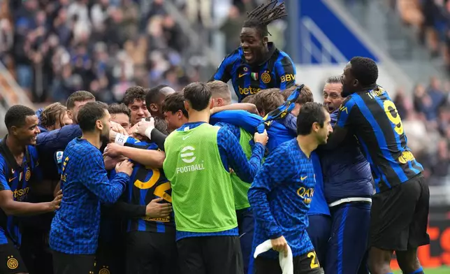 Inter Milan's Piotr Zielinski is celebrated by teammates after scoring his side's second goal during the Serie A soccer match between Inter Milan and Fiorentina, in Milan, Italy, Sunday, Oct. 25, 2026. (AP Photo/Antonio Calanni)