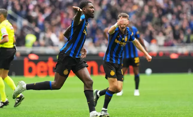 Inter Milan's Marcus Thuram celebrates scoring his side's opening goal during the Serie A soccer match between Inter Milan and Fiorentina, in Milan, Italy, Sunday, Oct. 25, 2026. (AP Photo/Antonio Calanni)
