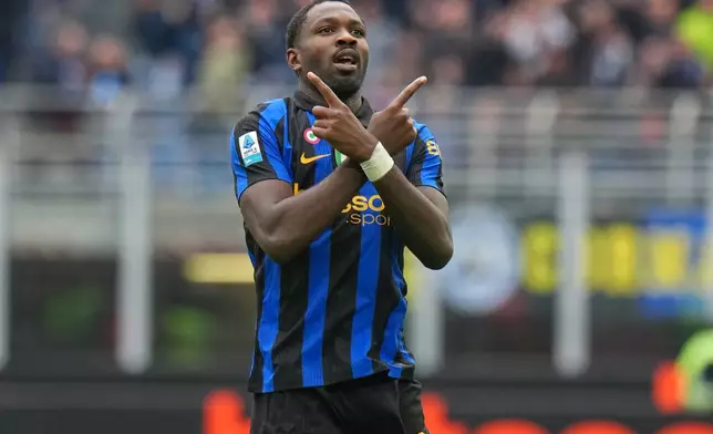 Inter Milan's Marcus Thuram celebrates scoring his side's opening goal during the Serie A soccer match between Inter Milan and Fiorentina, in Milan, Italy, Sunday, Oct. 25, 2026. (AP Photo/Antonio Calanni)