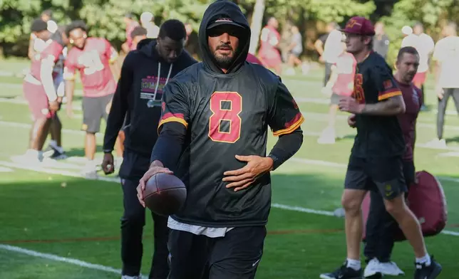 Washington Commanders quarterback Marcus Mariota (8) takes part in a NFL Football practice session in London, Wednesday, Sept. 30, 2026. (AP Photo/Alastair Grant)