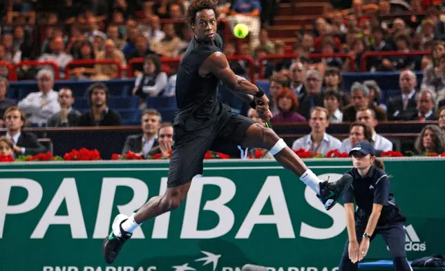 FILE - Gael Monfils, of France, returns the ball to Marin Cilic, of Croatia, during BNP Masters indoor tennis tournament in Paris, Friday, Nov. 13, 2009. (AP Photo/Michel Euler, File)
