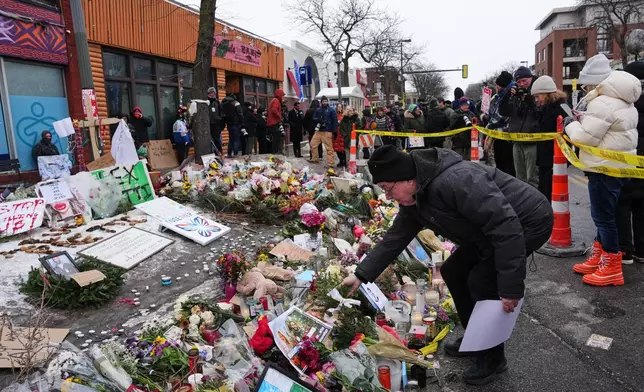 FILE - People visit a makeshift memorial for Alex Pretti, who was fatally shot by a U.S. Border Patrol officer over the weekend, Jan. 26, 2026, in Minneapolis. (AP Photo/Adam Gray, File)