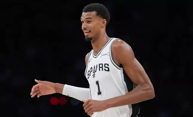San Antonio Spurs forward Victor Wembanyama (1) reacts to a play during the second half of a preseason NBA basketball game against the Phoenix Suns in San Antonio, Wednesday, Oct. 14, 2026. (AP Photo/Eric Gay)