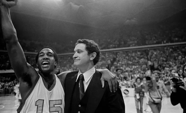 FILE - Marquette player Butch Lee, left, and coach Al McGuire celebrate after their team won over The University of North Carolina at Charlotte in the NCAA college basketball semifinals in Atlanta, March 26, 1977. Marquette won 51-49 with a last-second shot. (AP Photo/File)