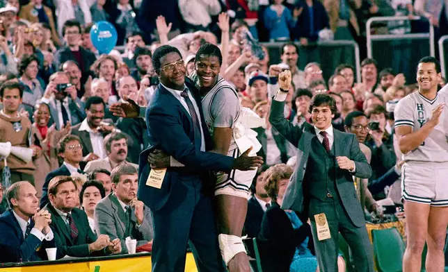 FILE - Georgetown head coach John Thompson, left, embraces most valuable player Patrick Ewing, after Georgetown defeated Houston 84-75 in Seattle on April 2, 1984. (AP Photo/File)