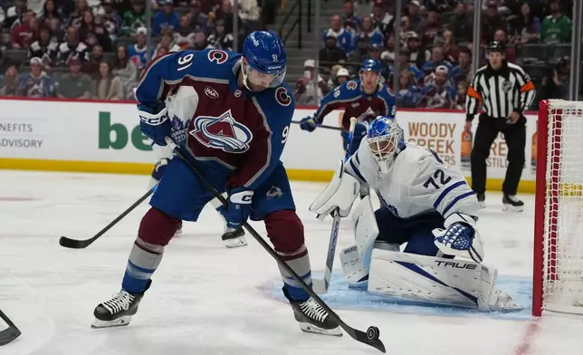 Colorado Avalanche center Nazem Kadri, left, looks to shoot against Toronto Maple Leafs goaltender Sergei Bobrovsky (72) in the first period of an NHL hockey game Saturday, Oct. 10, 2026, in Denver. (AP Photo/David Zalubowski)