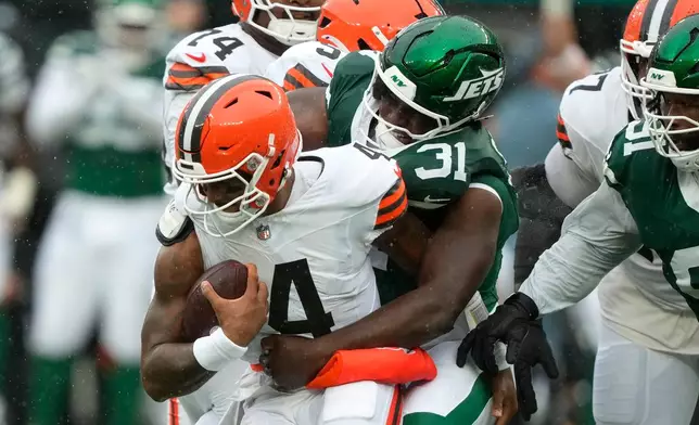 Cleveland Browns quarterback Deshaun Watson (4) is sacked by New York Jets linebacker David Bailey (31) during the first half of an NFL football game, Sunday, Oct. 11, 2026, in East Rutherford, N.J. (AP Photo/Yuki Iwamura)