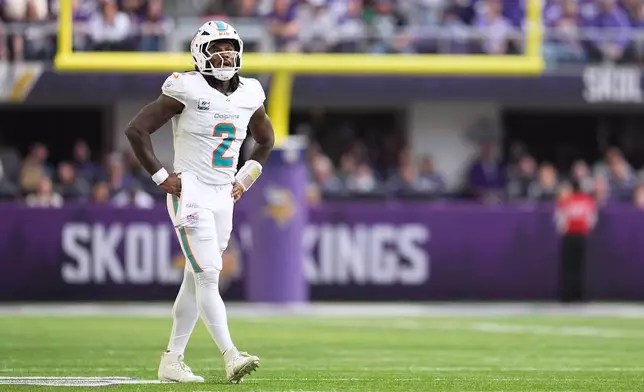Miami Dolphins quarterback Malik Willis reacts after a touchdown pass to wide receiver Chris Bell was called back against the Minnesota Vikings during the first half of an NFL football game Sunday, Oct. 4, 2026, in Minneapolis. (AP Photo/Abbie Parr)