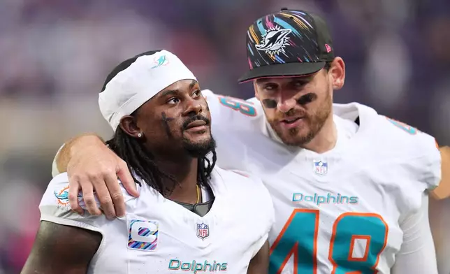 Miami Dolphins quarterback Malik Willis, left, and punter Bradley Pinion leave the field following an NFL football game against the Minnesota Vikings, Sunday, Oct. 4, 2026, in Minneapolis. (AP Photo/Abbie Parr)