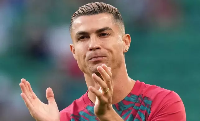Portugal's Cristiano Ronaldo, wearing a wedding band, claps his hands during warmup before the Nations League soccer match between Portugal and Wales in Lisbon, Thursday, Sept. 24, 2026. (AP Photo/Armando Franca)