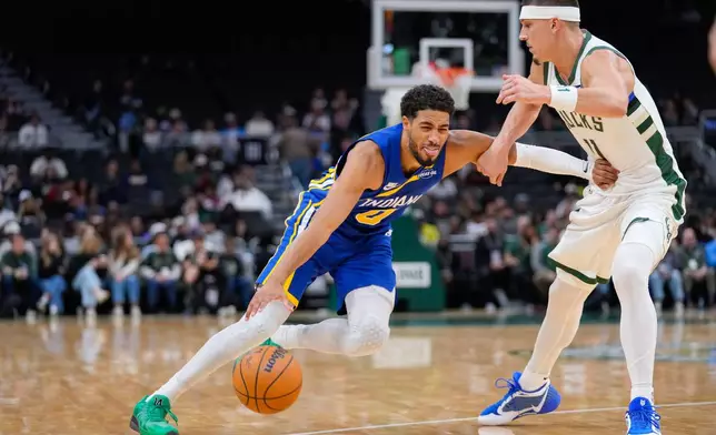Indiana Pacers guard Tyrese Haliburton, left, dribbles against Milwaukee Bucks guard Tyler Herro, right, during the first half of an NBA basketball game Monday, Oct. 26, 2026, in Milwaukee. (AP Photo/Kayla Wolf)