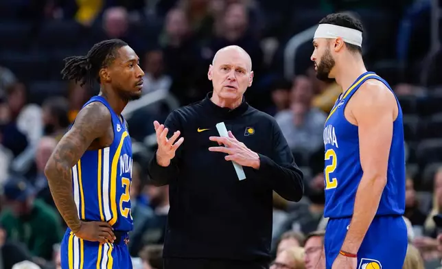 Indiana Pacers head coach Rick Carlisle, center, talks with Aaron Nesmith, left, and Larry Nance Jr., right, during the first half of an NBA basketball game against the Milwaukee Bucks, Monday, Oct. 26, 2026, in Milwaukee. (AP Photo/Kayla Wolf)