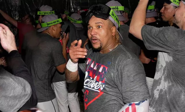 Cleveland Guardians third baseman José Ramírez celebrates with teammates in the locker room after Game 5 of baseball's American League Division Series against the Chicago White Sox, Saturday, Oct. 10, 2026, in Cleveland. (AP Photo/Sue Ogrocki)