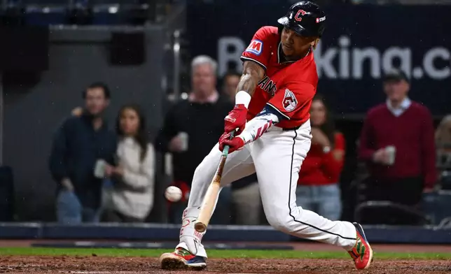 Cleveland Guardians' José Ramírez hits a home run in the fourth inning of Game 5 of baseball's American League Division Series against the Chicago White Sox, Saturday, Oct. 10, 2026, in Cleveland. (AP Photo/Phil Long)